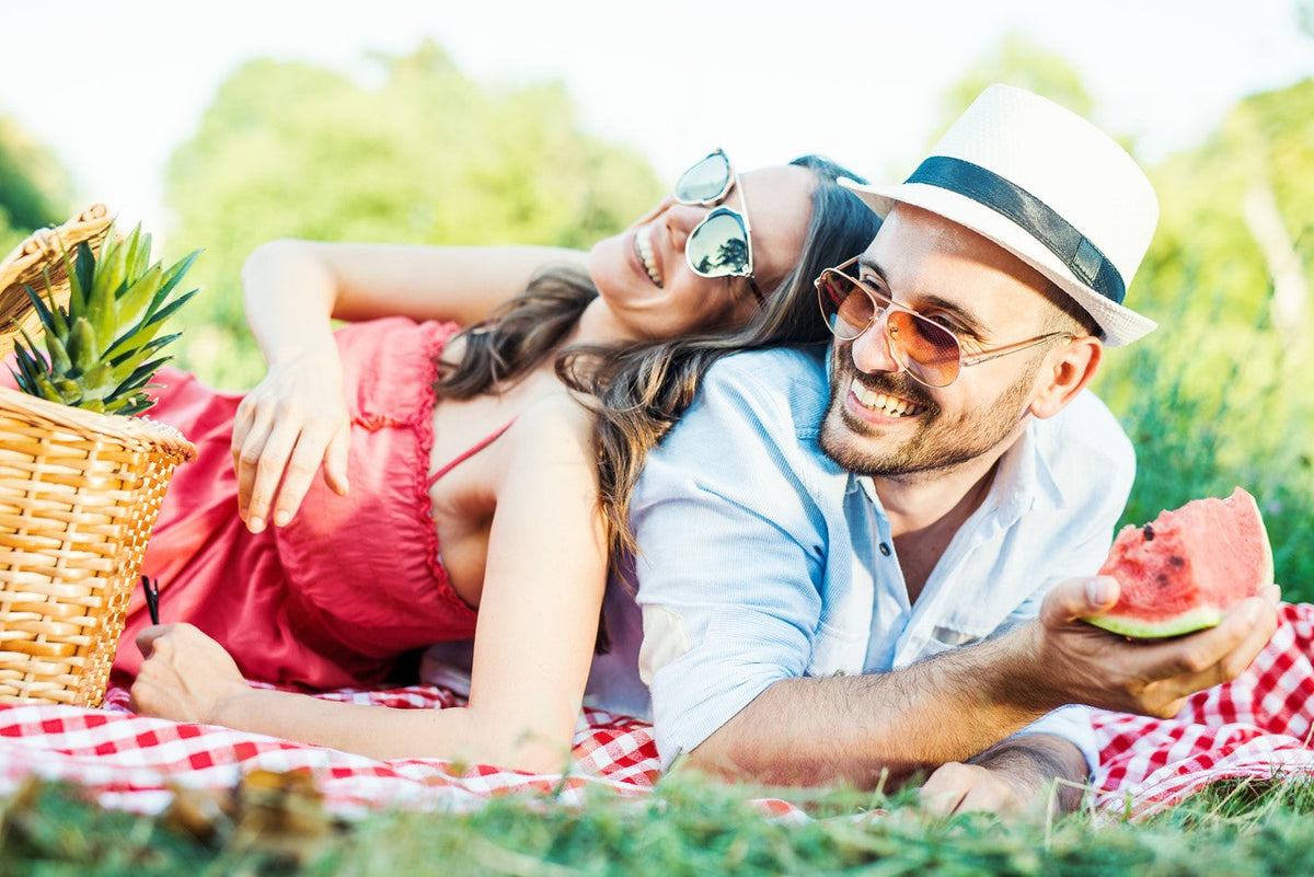 couple laying on picknick blanket