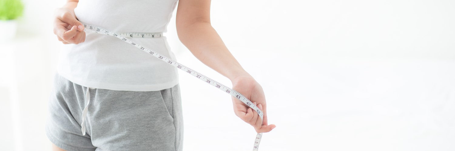 woman measuring waist
