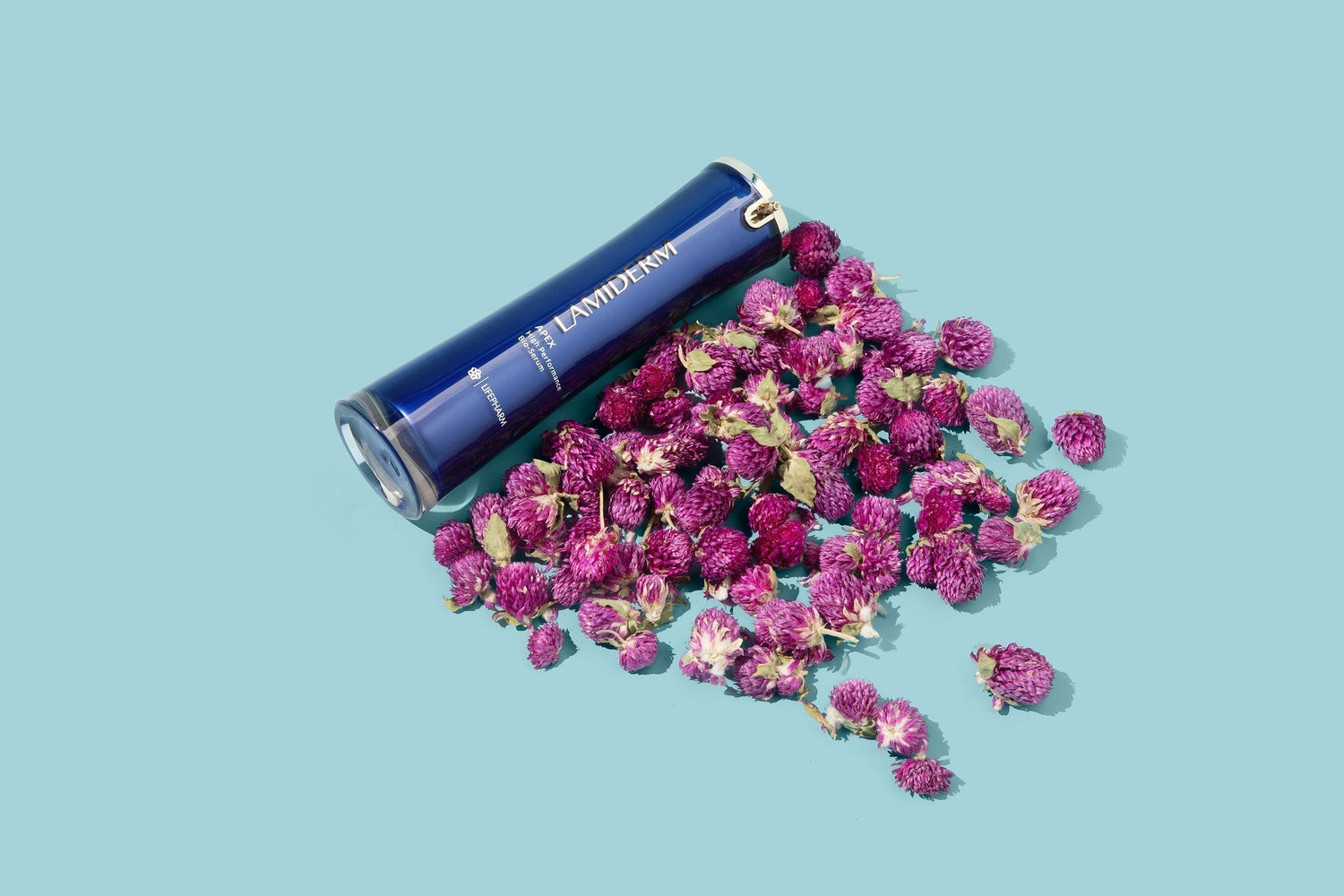 lamiderm bottle with babchi flowers