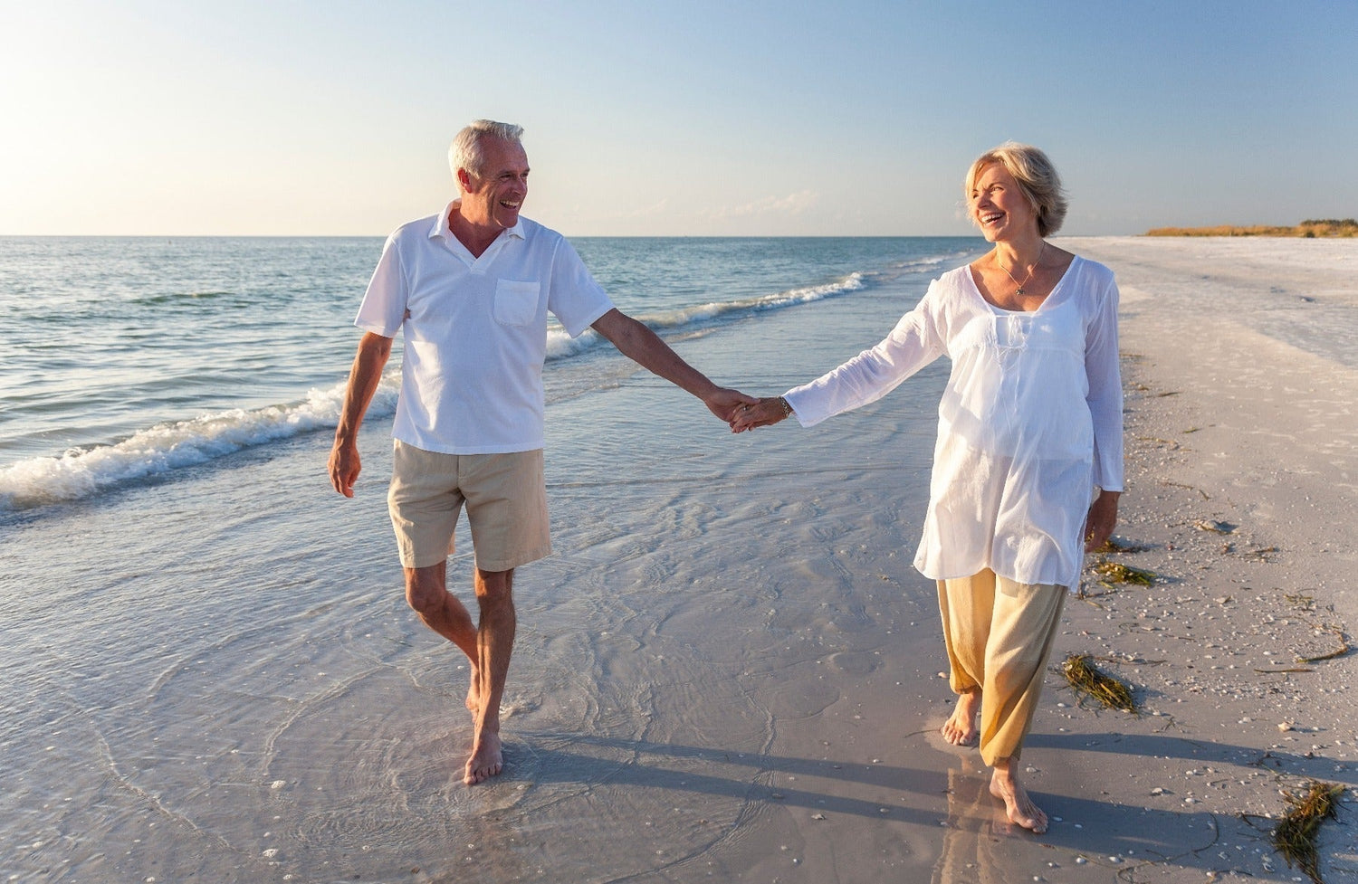 couple walking on beach shore