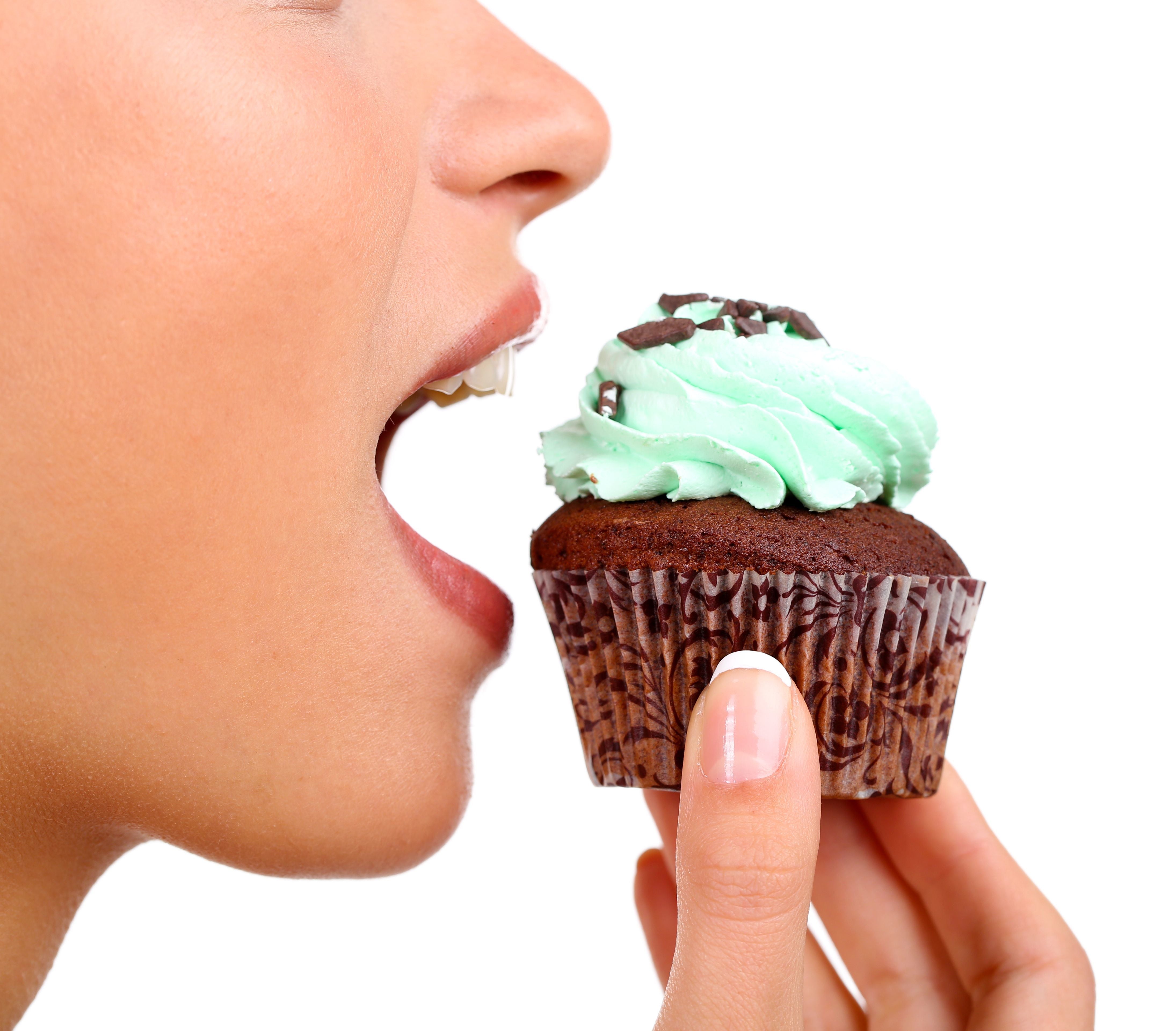 woman eating muffin