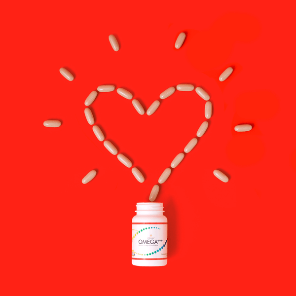 omega+++ pills forming a heart, red background